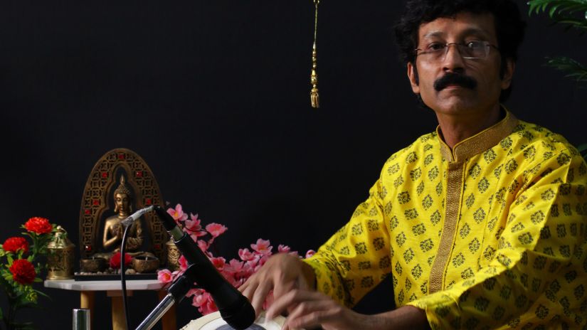 A person playing a tabla - New Year in Goa