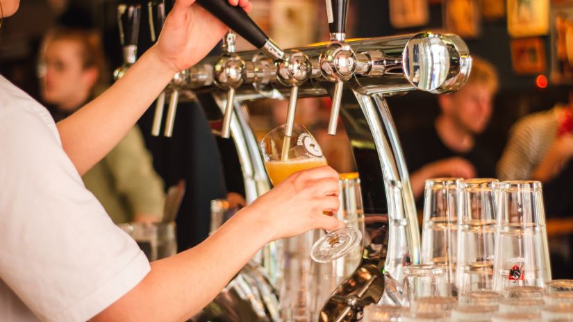 beer being poured into a glass