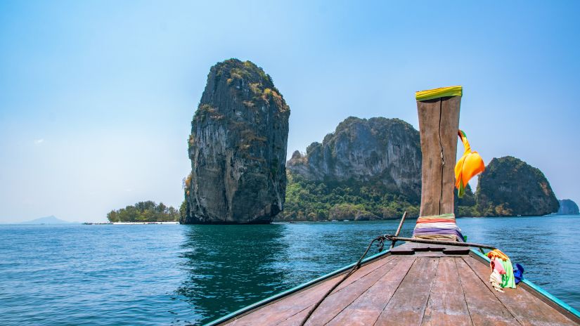 boat sailing towards rocky islands