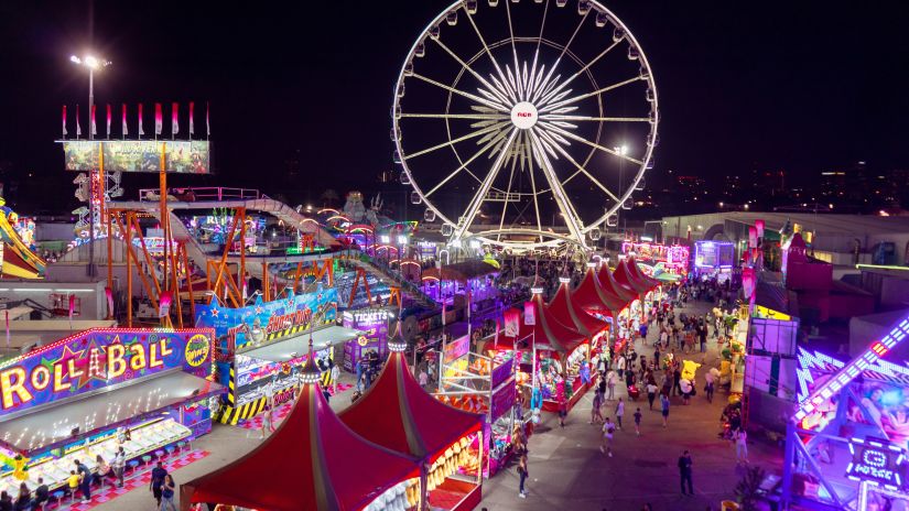 the ferris wheel and other stalls and decorations at a fete