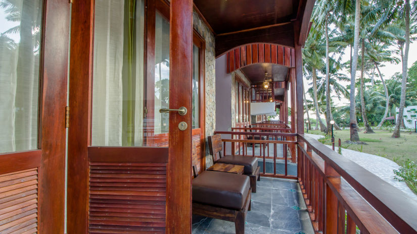 the balcony area with seats inside Neil Ocean Suite - Symphony Summer Sand Beach Resort And Spa, Neil Island