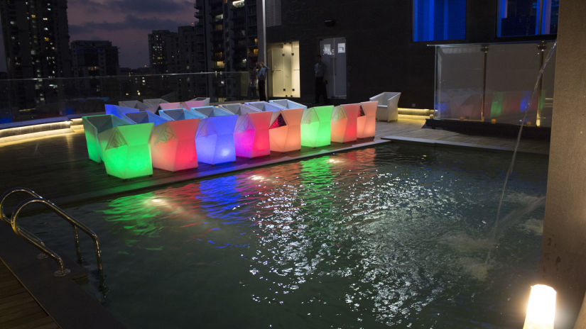 The Empresa Boutique Hotel - the rooftop area with colourful seats beside the swimming pool