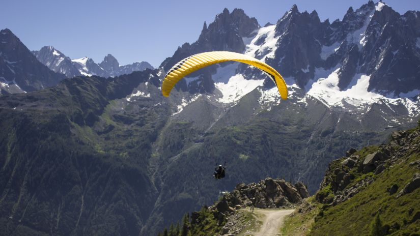 A person Para Gliding in a mountainous region