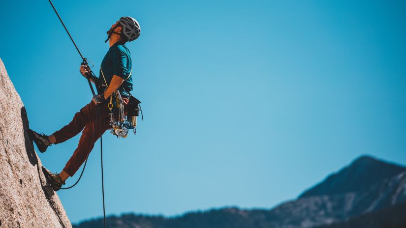 A person rock climbing using protective gear