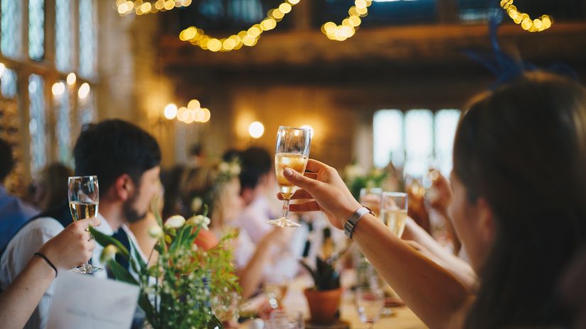 people raising their glasses for a toast