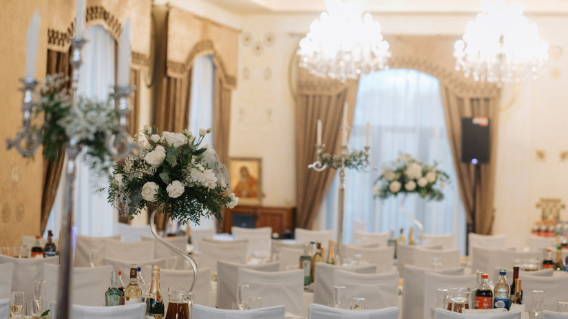 event hall for parties with white chairs and flower decoration