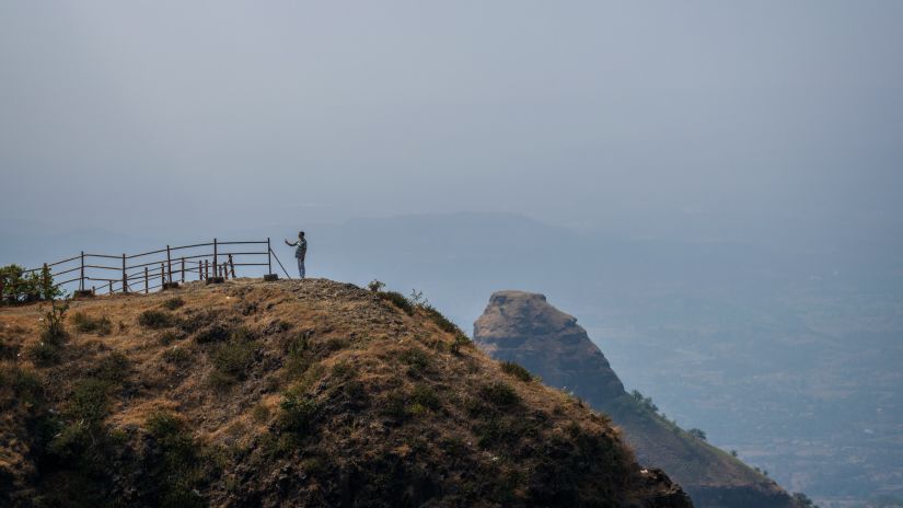 people at the peak of a hill in lonavala 