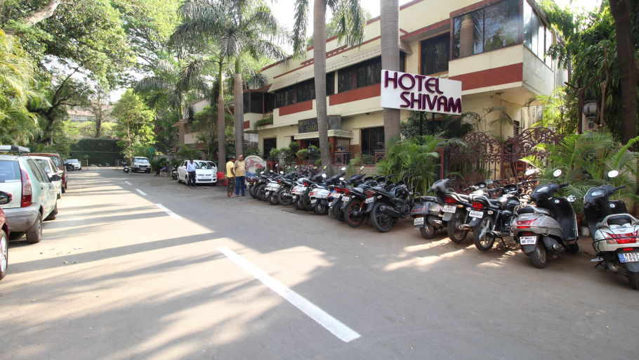 Outer view of Facade of Hotel Shivam, Pune featuring a parking area