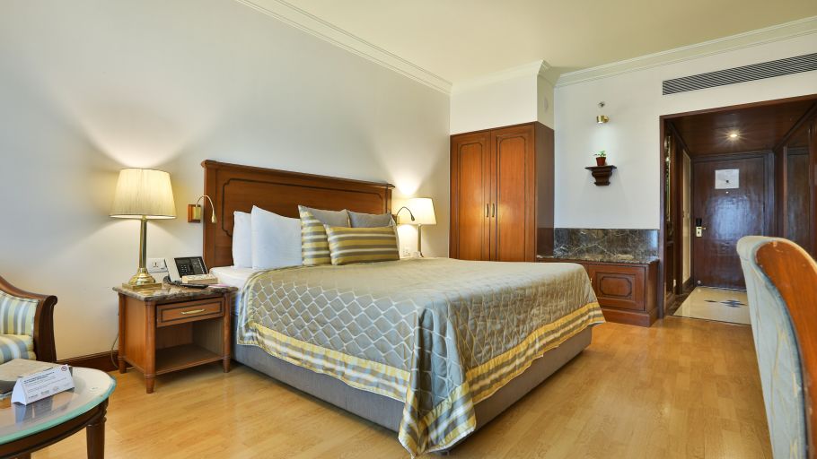 room with a cosy king size bed and wooden flooring