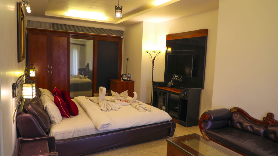 a double bed inside Luxury Villa - White pearl suites by rosetum 