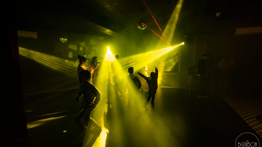 Yellow laser lights on party hall in The Bourbon Club N Lounge at The Tattva Boutique Resort, Joshimath