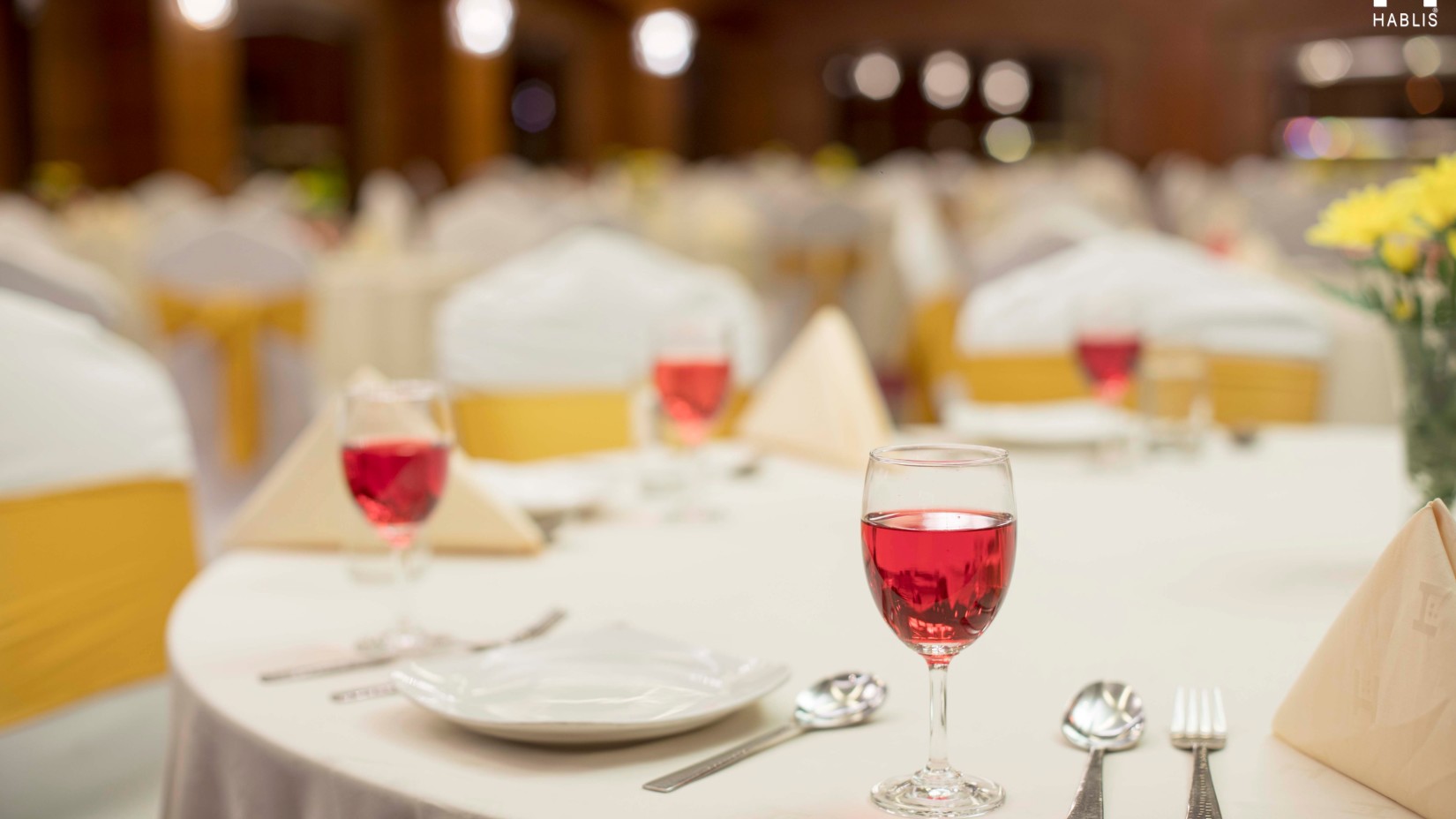 Plates, cutlery and welcome drink on table at Hablis Hotel, Chennai 