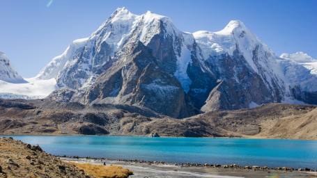 A long shot of the mountains and a lake