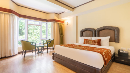 room with a king size bed and windows overlooking the beautiful surroundings at summit lillium