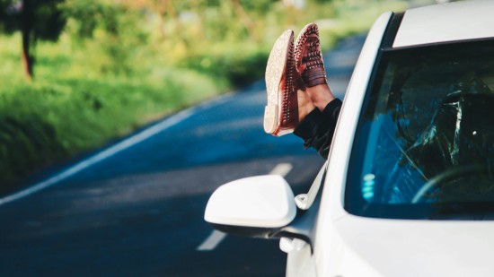 legs hanging out from car window 