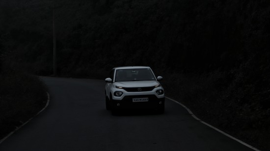 a car driving on a road at night