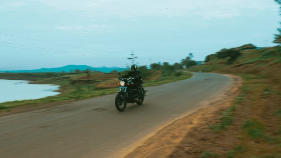 a bike on a road beside a water body