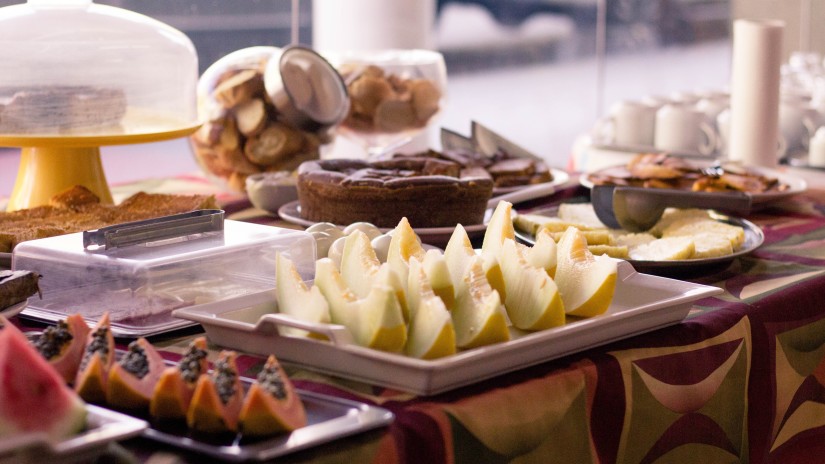 a close up shot of Slices of fruits and breads on a table