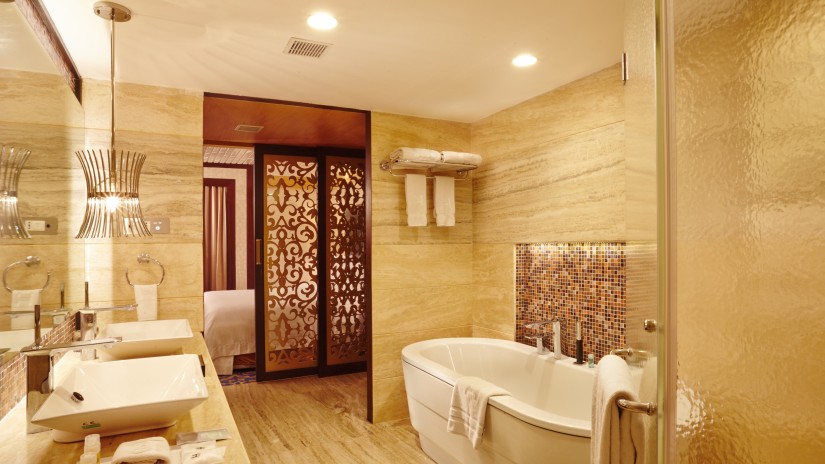 Bathroom of hablis suite with a bathtub and toiletries at Hablis Hotel, Chennai