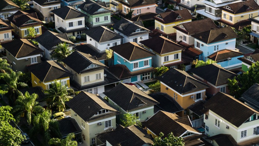 An aerial shot of multiple houses with trees surrounding it