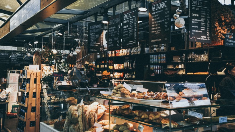 a close up image of a dimly lit bakery with many items on sale