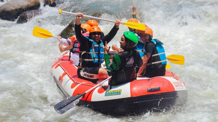 A group of people rafting on an inflatable boat