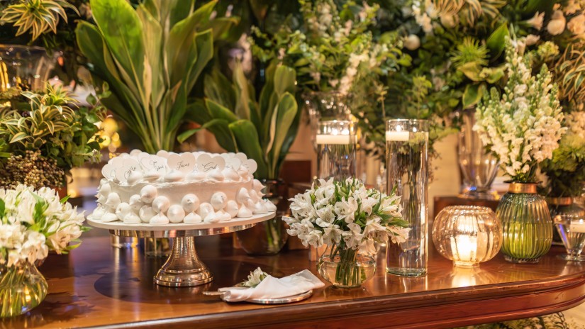 A beautifully decorated wedding cake on a dining table