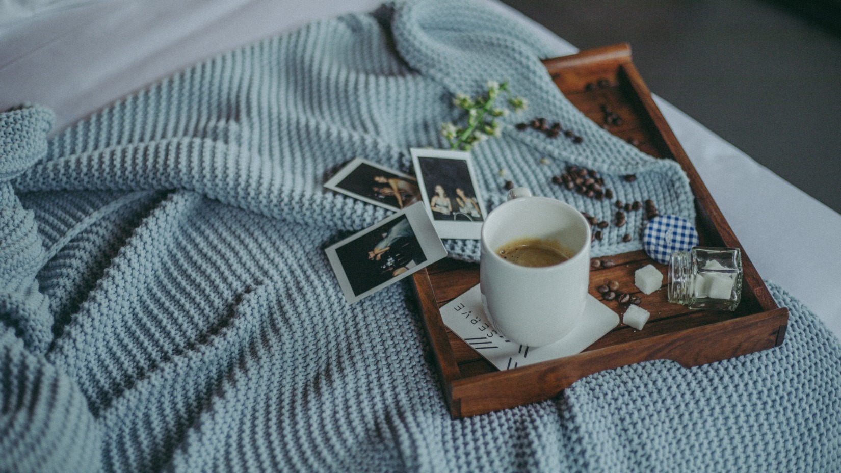 A tray with a cup of coffee sits on the bed - Villa in Palms by V Escapes