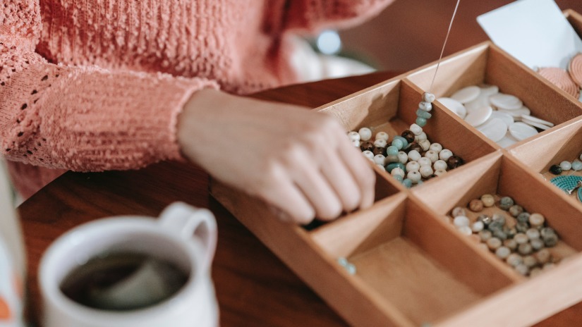 a person sorting beads