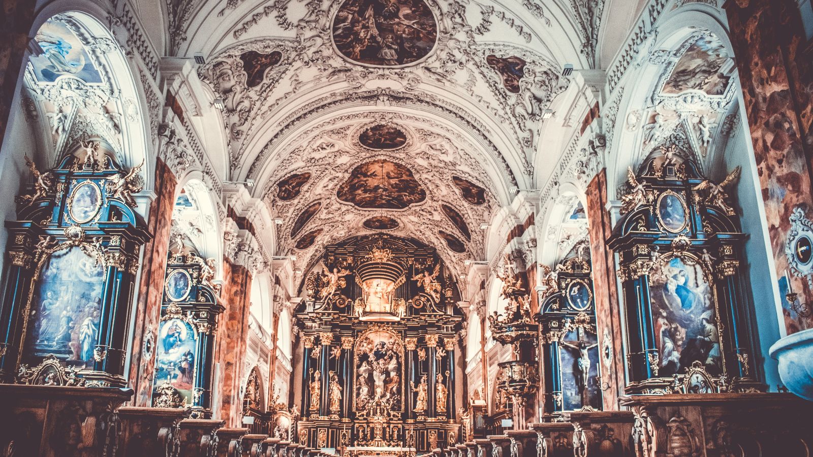 Interior of a Cathedral with intricate architecture and paintings