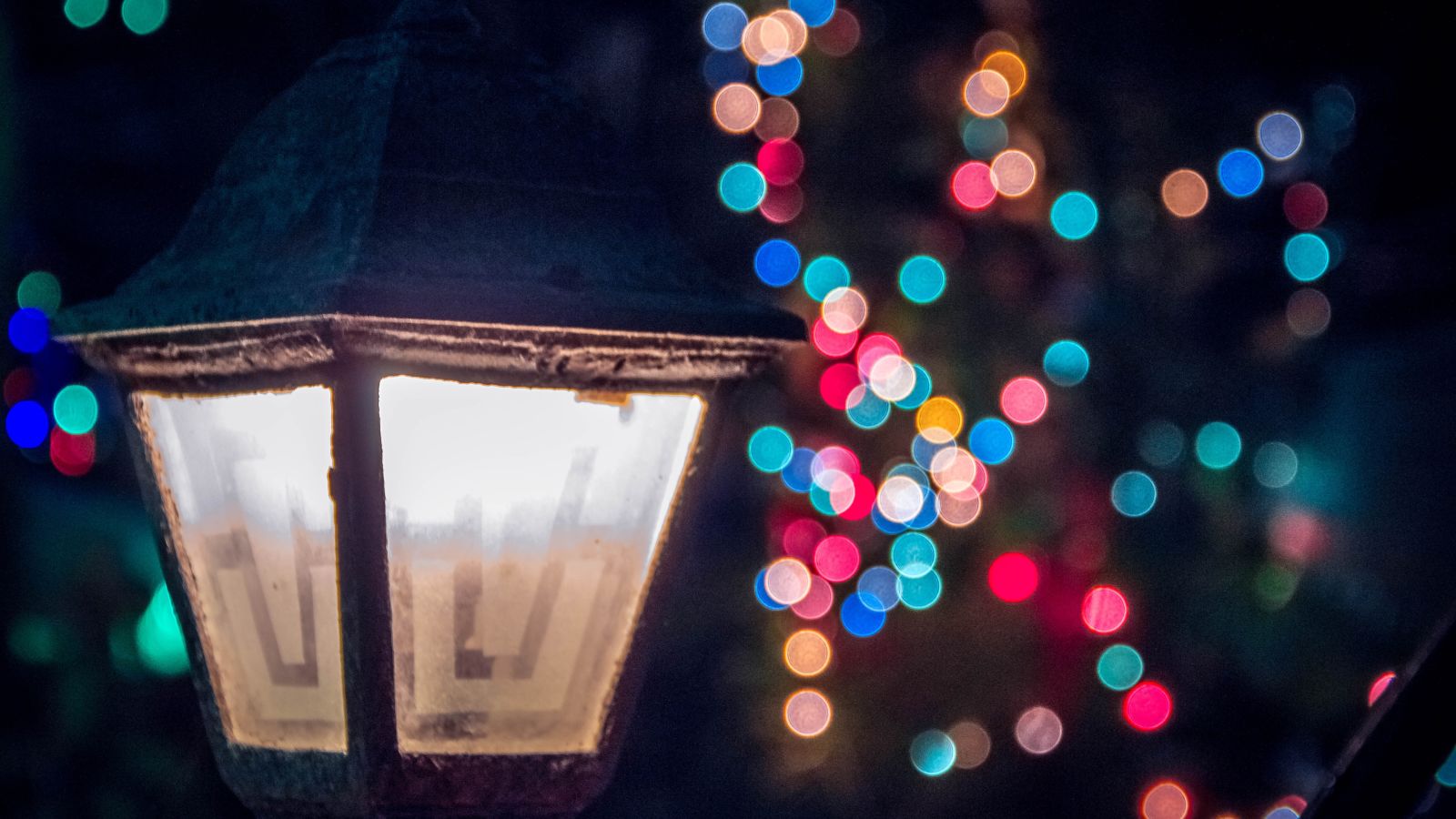 a Lit lamp during the night and led lights in the background being blurred