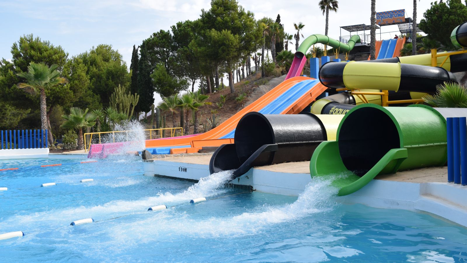 Water slides at a water park with a small pool at the bottom