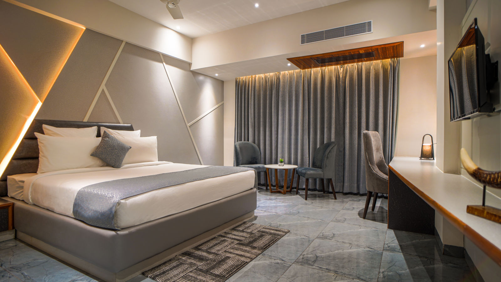 Contemporary hotel room with a plush bed, modern furniture and soft lighting - Coral Reef Hotel & Spa, Port Blair