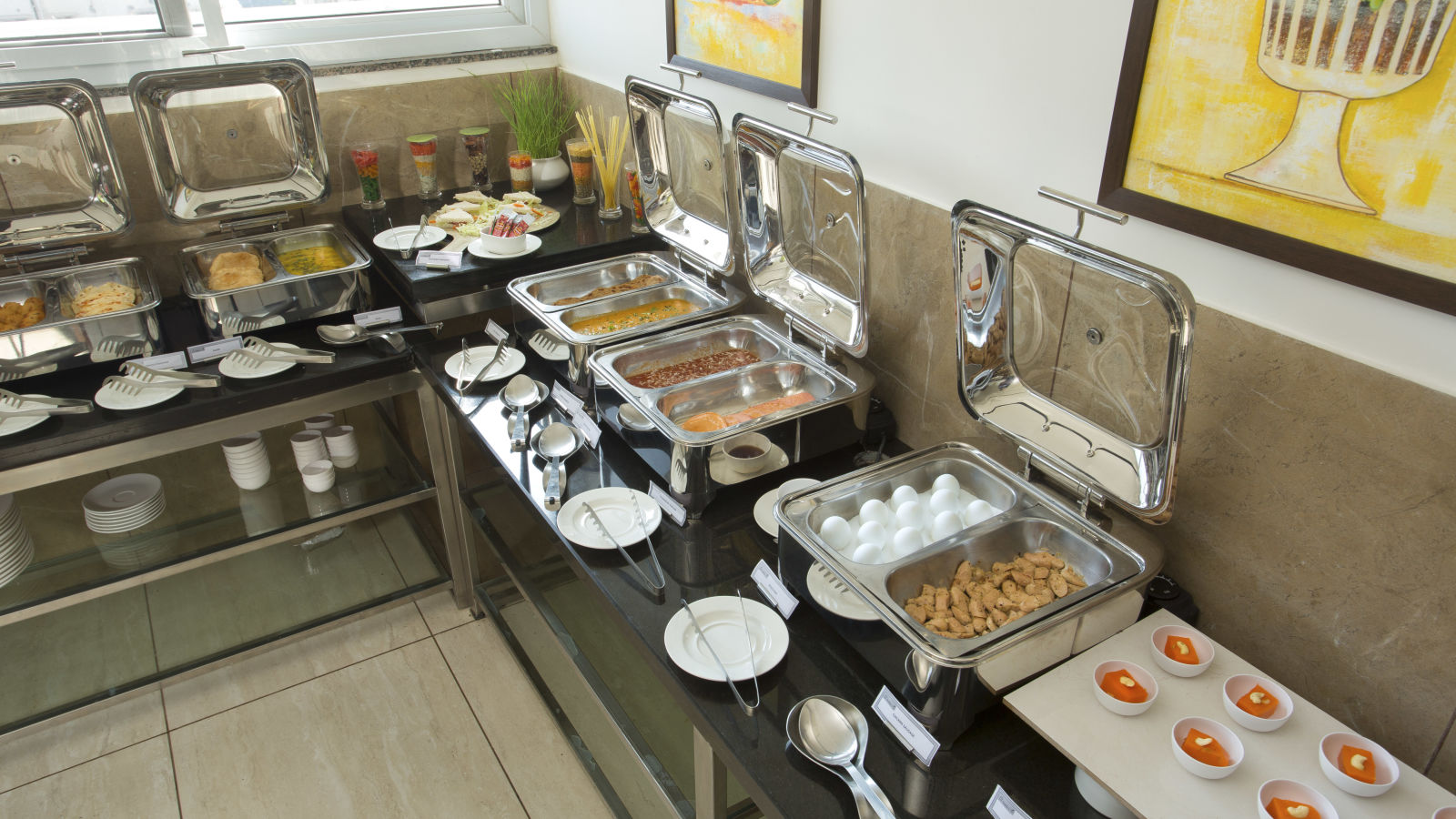 A hotel buffet station featuring a variety of hot dishes - De Venetian by TGI, Brookefield