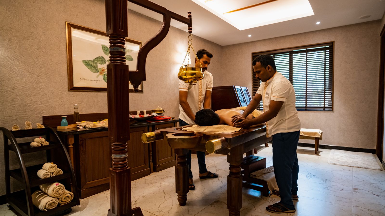 two therapists providing a massage to a client 