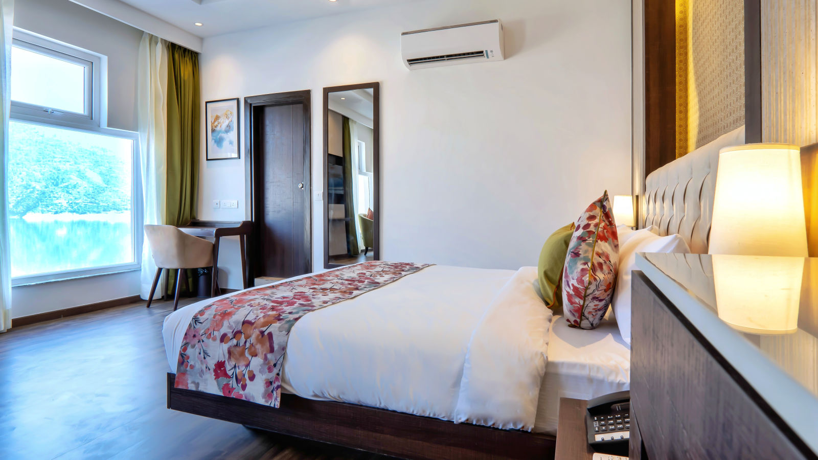 Premium Rooms with Lake View at Hotel Le ROI Lake View Koti with a beautiful view from the window next to the plush bed3