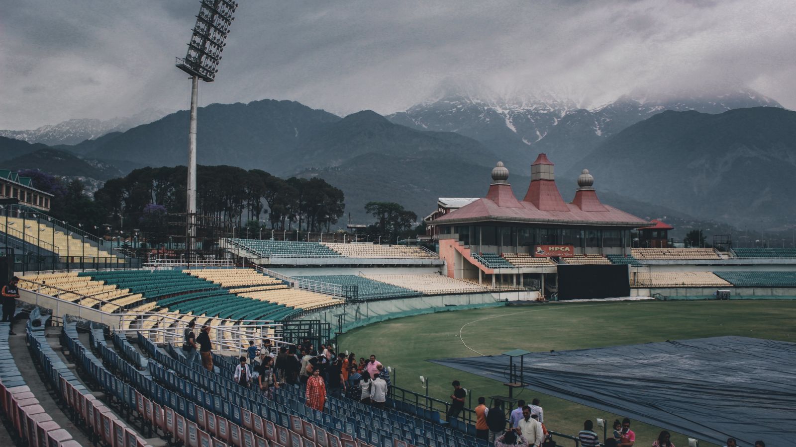 Image of Dharamshala Cricket Stadium on a cloudy day with the mountains in the backdrop
