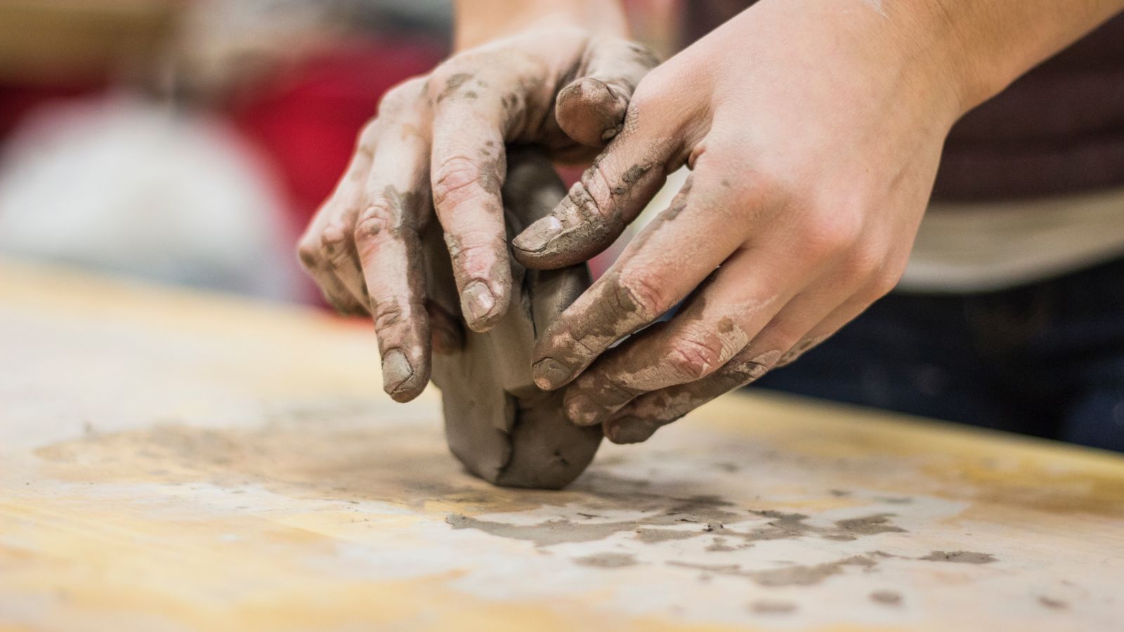 a person moulding clay