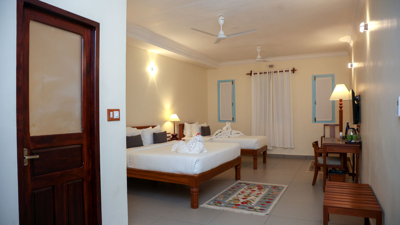 A master suite bedroom with two beds, tables and other furnitures  | Mango HIll La Serene, Ponicherry