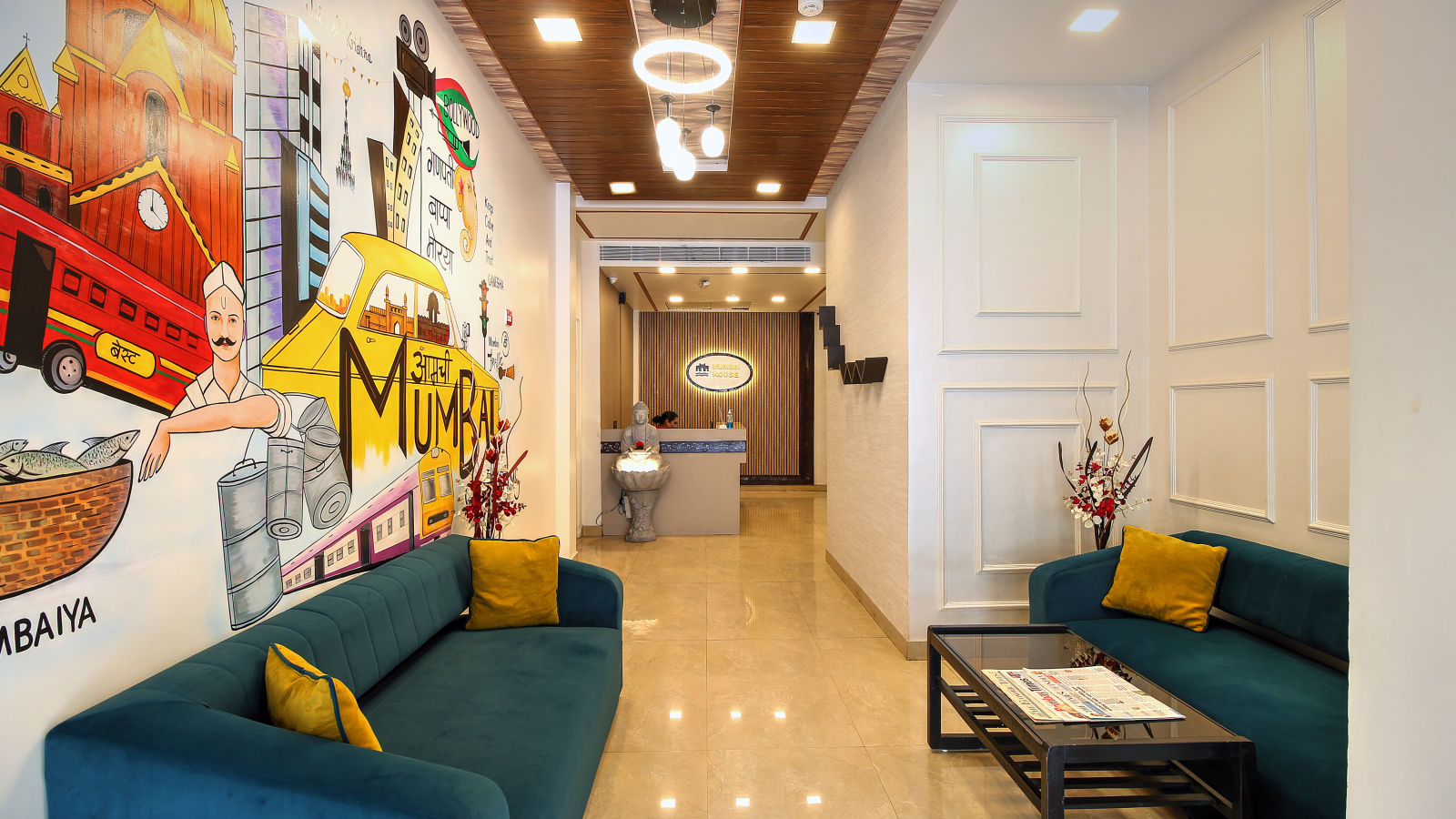 A vibrant lobby with a colorful mural wall representing Mumbai, plush sofas, and a front desk.