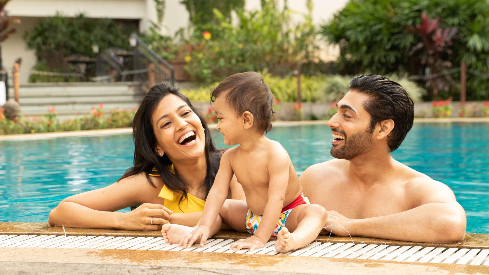 Parent and kid enjoying the swimming pool