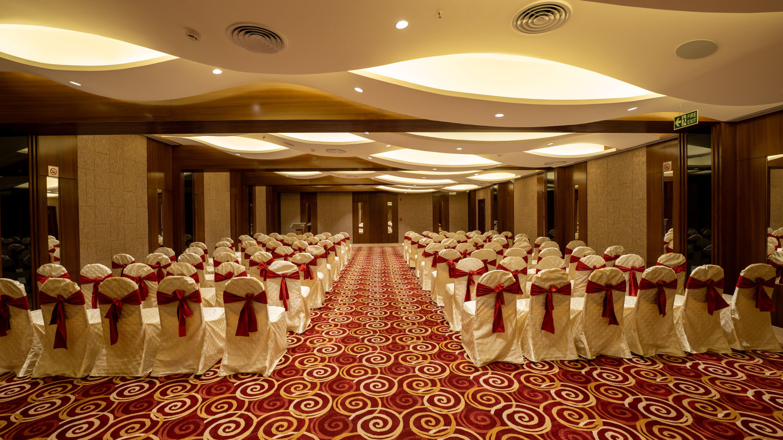 a row of chairs placed in a banquet hall at The President Hotel, Kumara Park, Bangalore