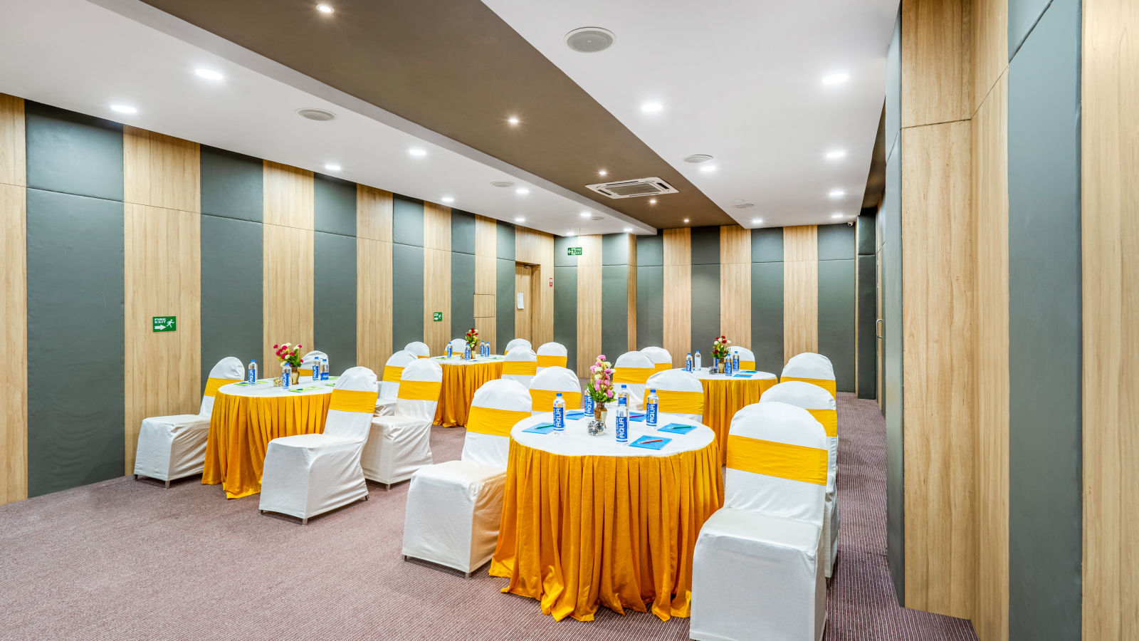 A well-furnished conference room displaying a table and chair at Westside Hotel