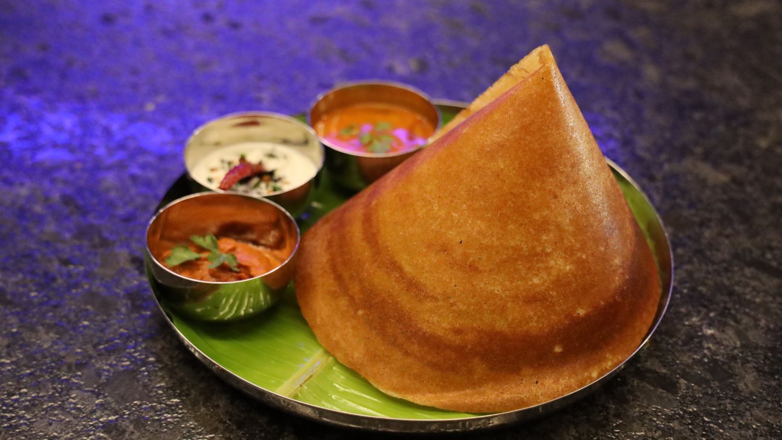 A plated dosa with chutney and sanmbhar in side bowls - Wonderla Bhubaneswar