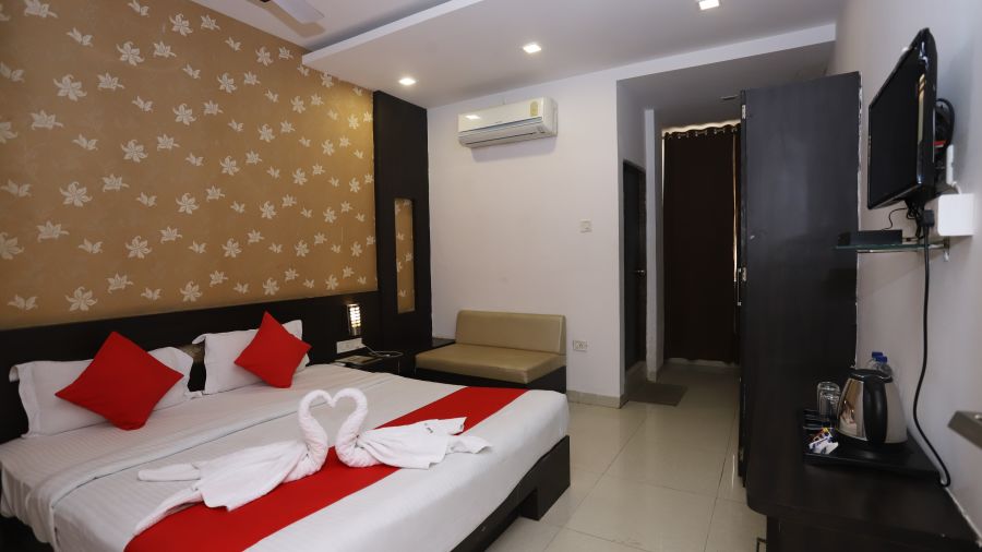 Superior Room decked with a king size bed, a wardrobe, a tv and an air-conditioner at Hotel Manaal By M Square, Pithampur