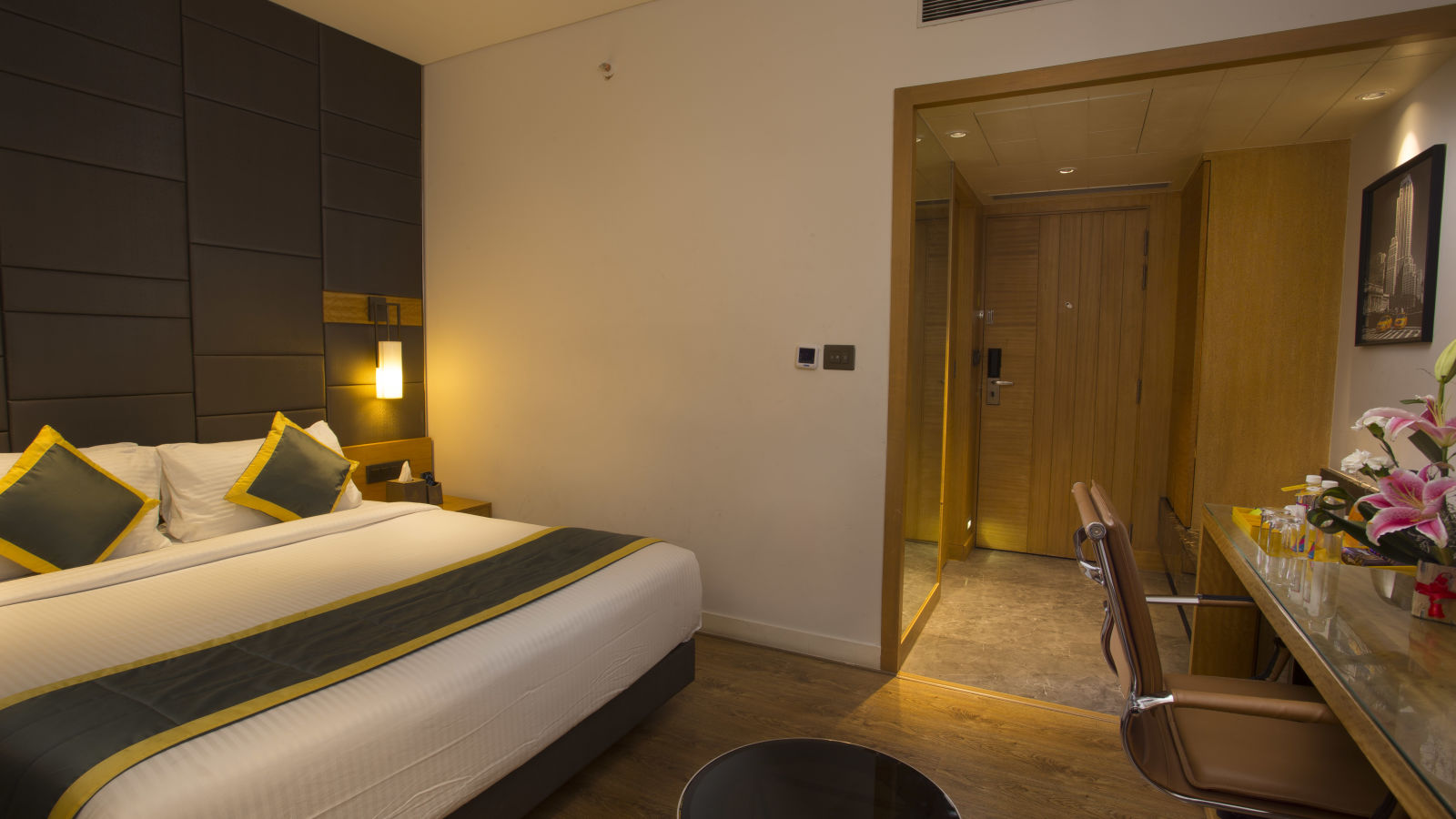 a bedroom with a large bed on the right side opposite to a work desk and chair  - Hotel Fountain Tree By TGI - JP Nagar, Bangalore