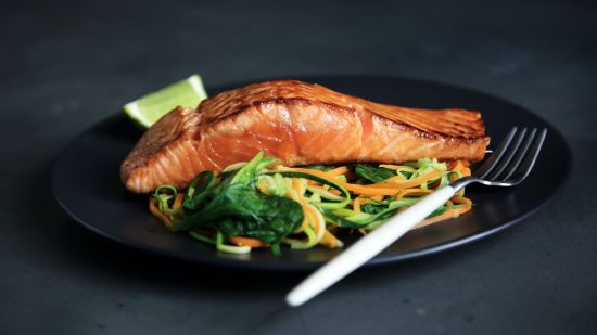 Cooked fish served on a black plate