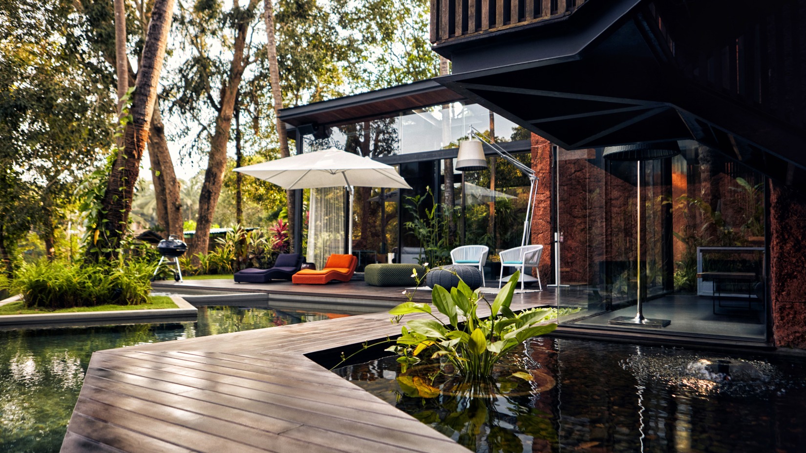 Exterior of the hotel features a walkway among trees and plants - Villa in Palms by V Escapes