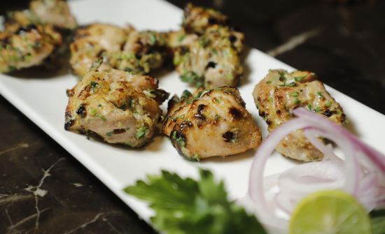 alt-text Udman By Ferns N Petals, Chattarpur - chicken malai tikka kebab at a restaurant table