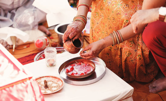 alt-text indian-bride-washes-nuts-plate-with-species-petals